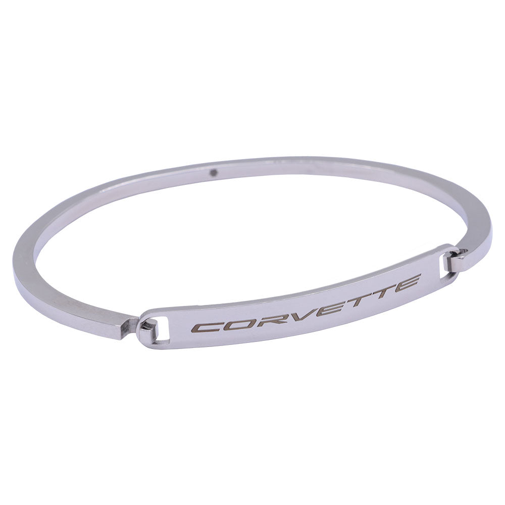 A silver-toned metal bangle bracelet featuring the word 'CORVETTE' engraved on its center band, shown against a plain white background.
