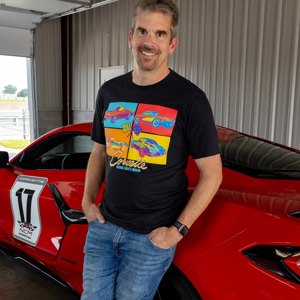 Man standing in front of a red Corvette wearing a Corvette Squares Pop Culture black T-shirt.