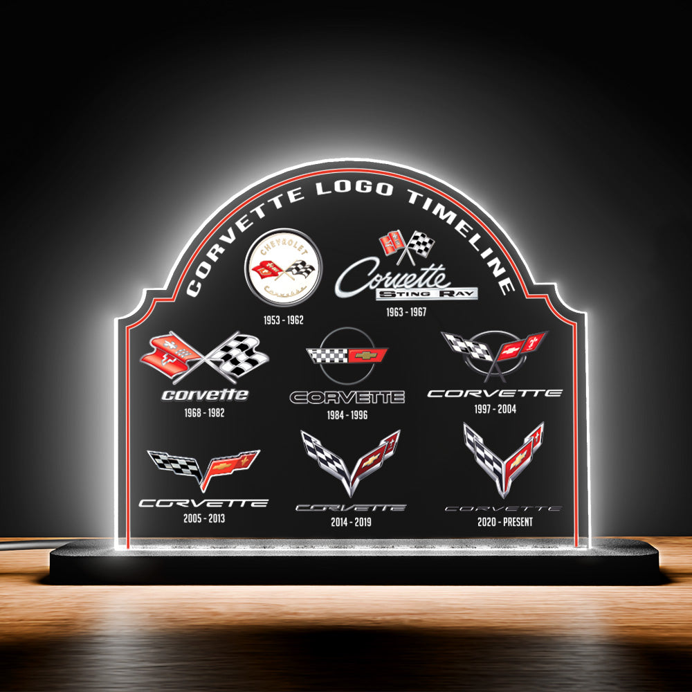 Corvette logo timeline display with illuminated back on a wooden desk surface