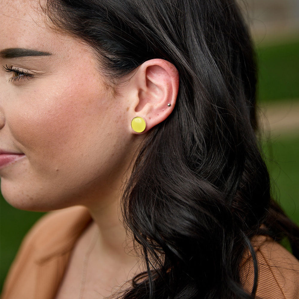 Model wearing the Crash Jewelry Accelerate Yellow Stud Earrings