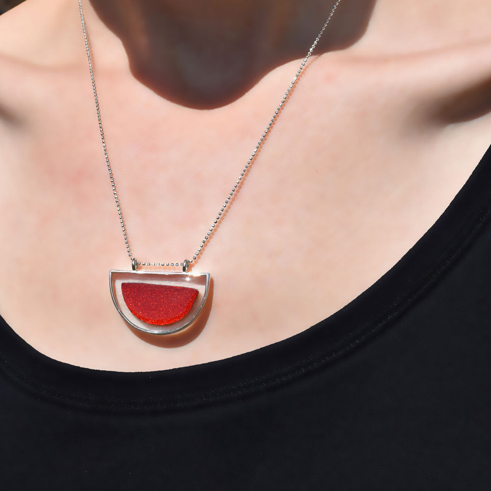 Lady wearing the Crash Jewelry Red Mist Half-Circle Necklace