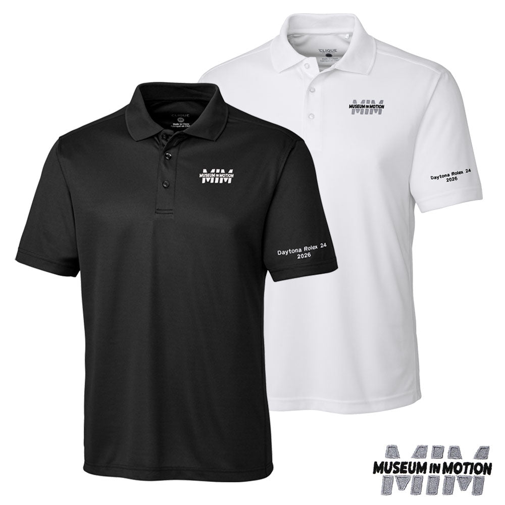 Two polo shirts shown on a white background: a black short-sleeve polo in front with a Museum in Motion logo on the left chest and tour name on the right sleeve, and a white short-sleeve polo behind with matching white embroidery. A 'Museum in Motion' logo appears in the bottom right corner.