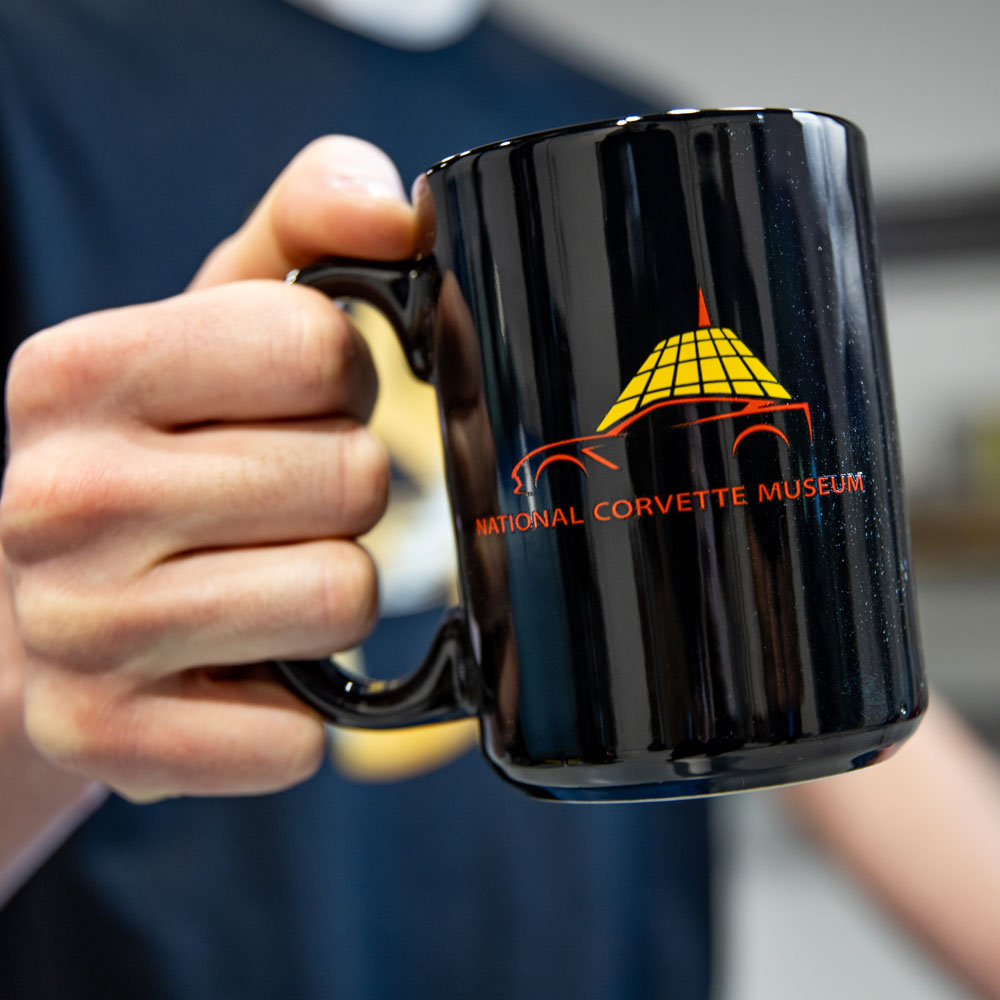 Man holding the NCM Skydome Black Mug