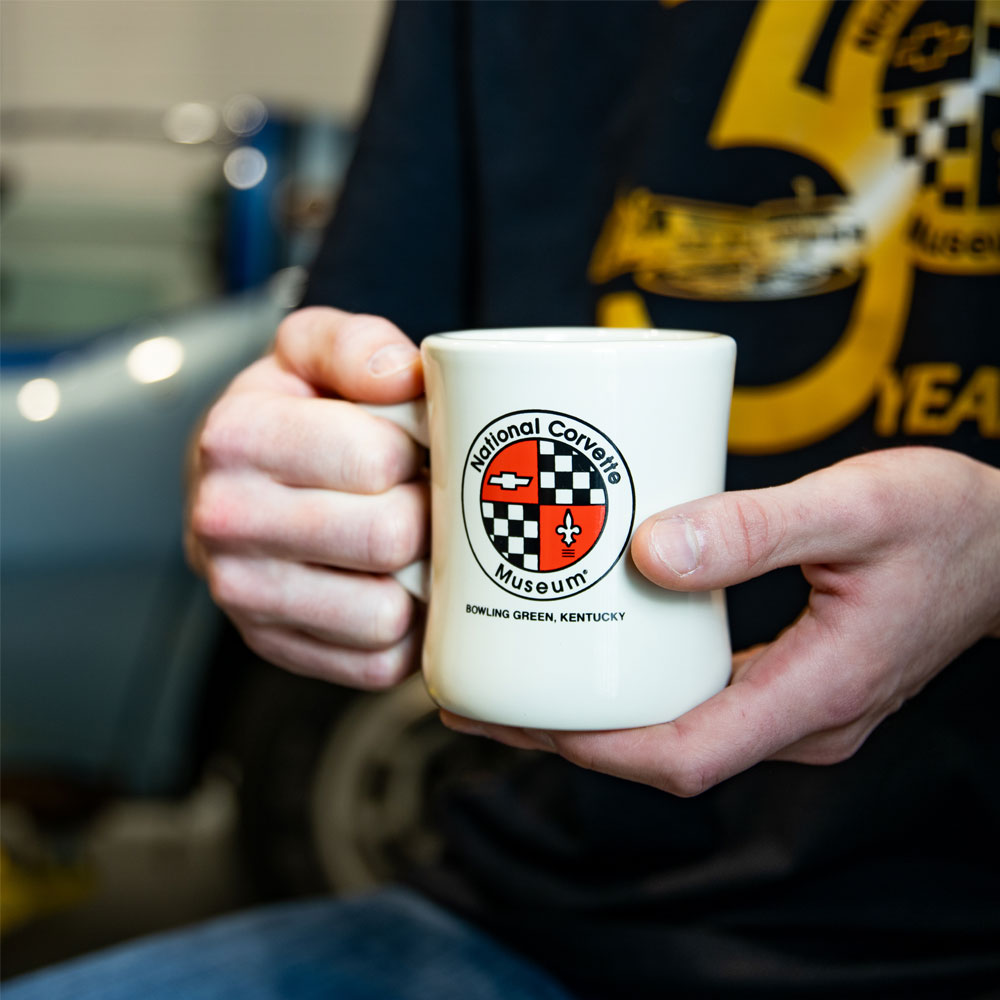 Person holding the NCM White Diner Mug