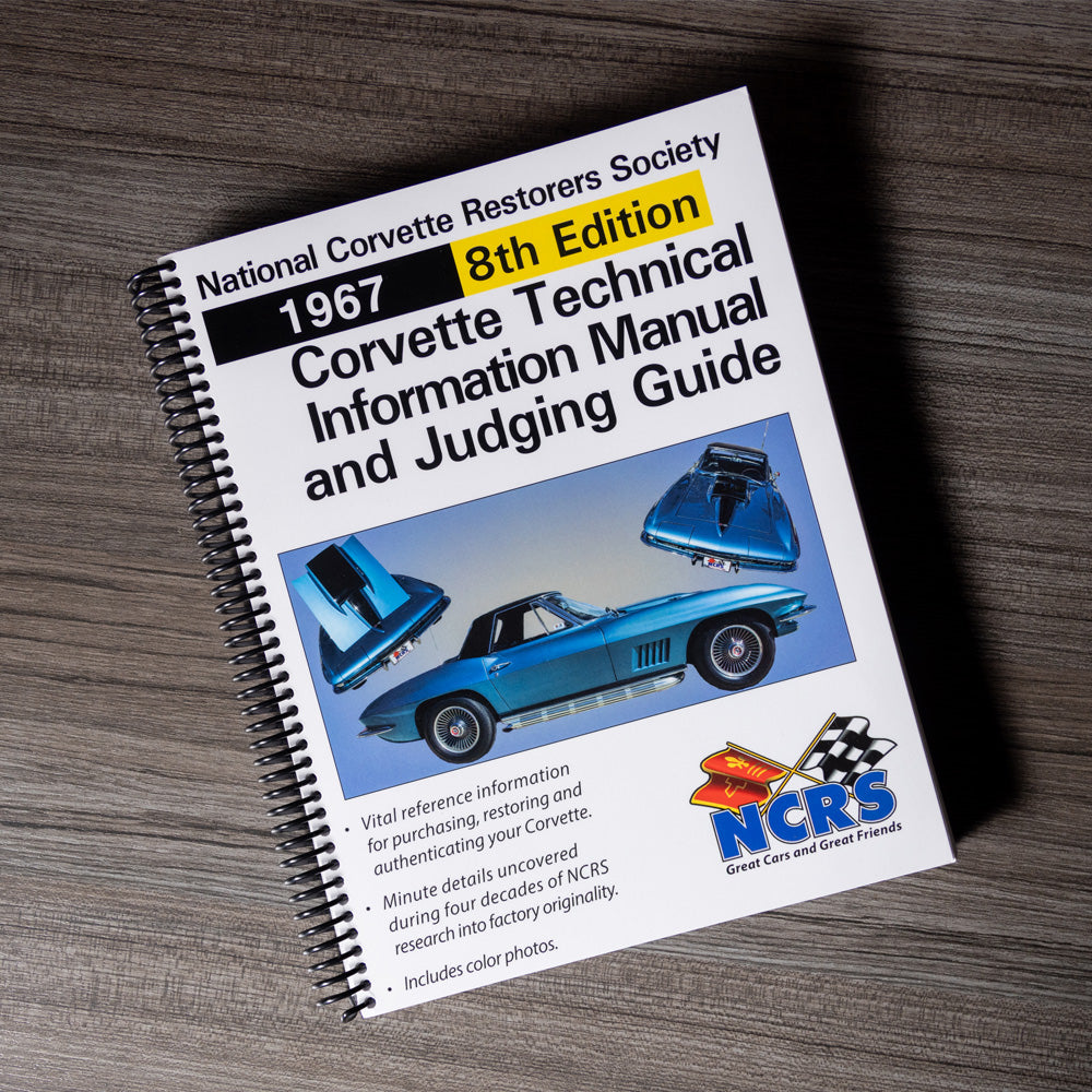Book titled '1967 8th Edition Corvette Technical Information Manual and Judging Guide' on a wooden surface