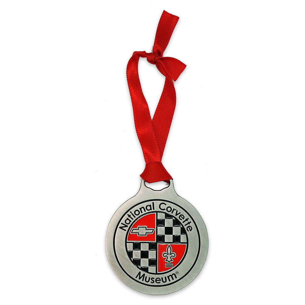 Metal ornament with red ribbon featuring the National Corvette Museum logo on a white background