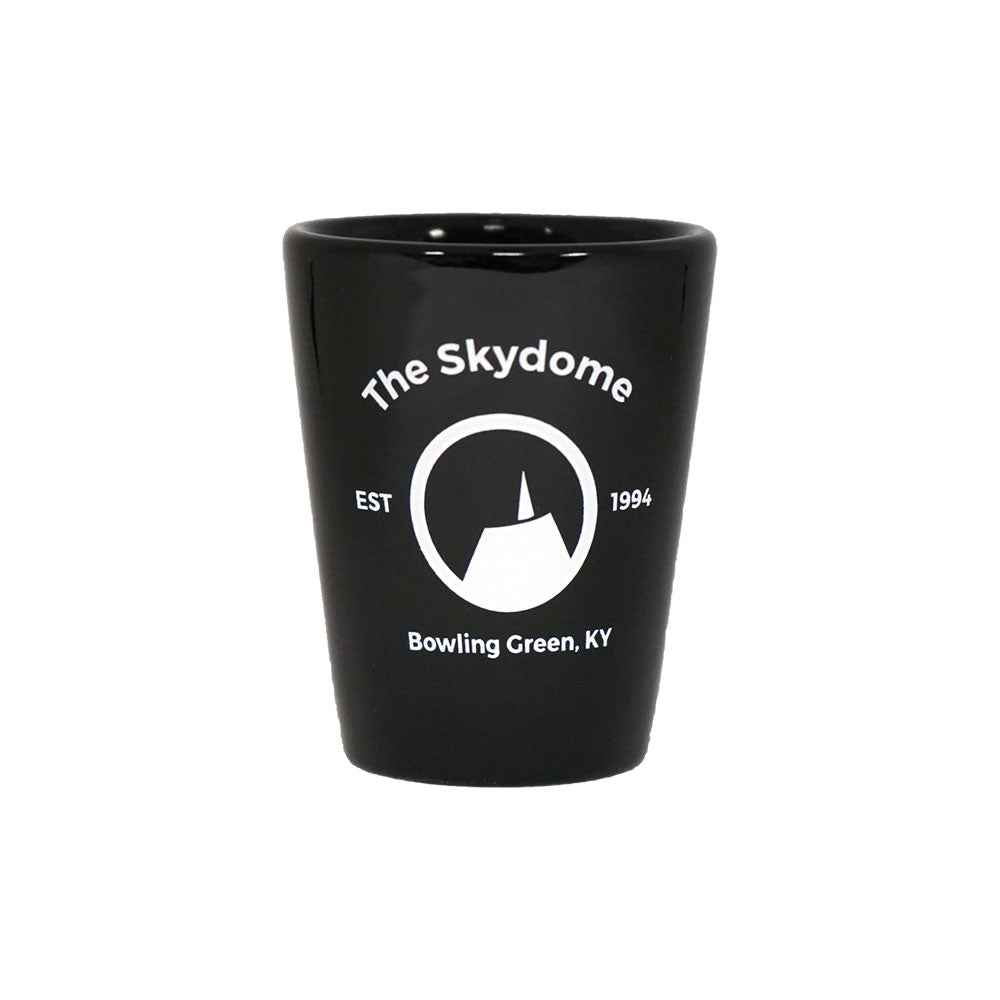 A black shot glass featuring the Skydome logo shown on a white background.