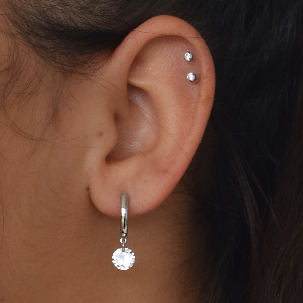 Woman wearing the Sterling Silver Hoop Earring Huggie with a Dangle CZ