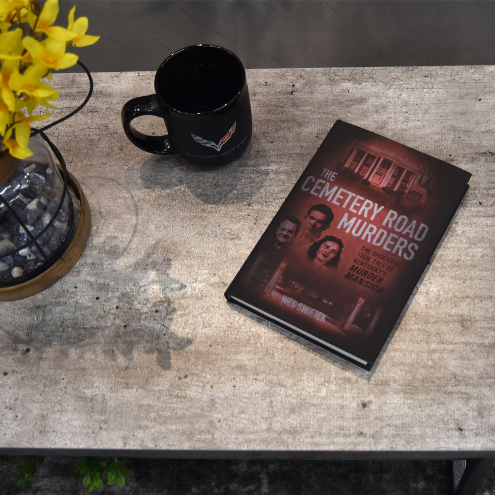 The Cemetery Road Murders Book laying on a coffee  table